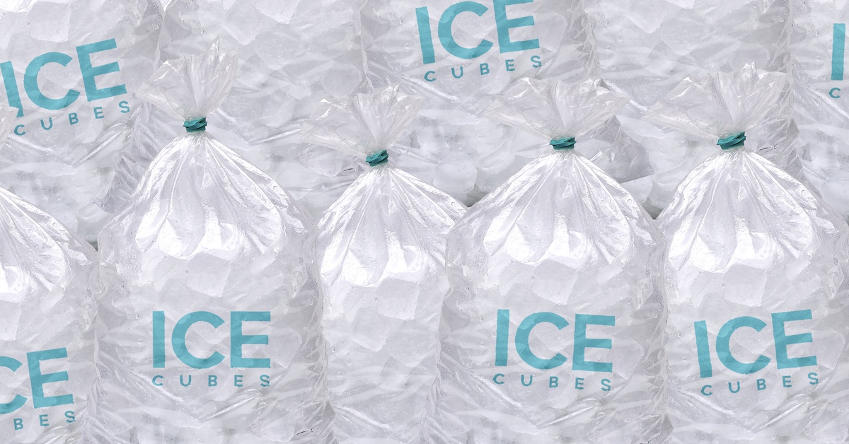 Several large bags of ice rest on top of each other. The front of the bags says "ICE CUBES" in blue font.
