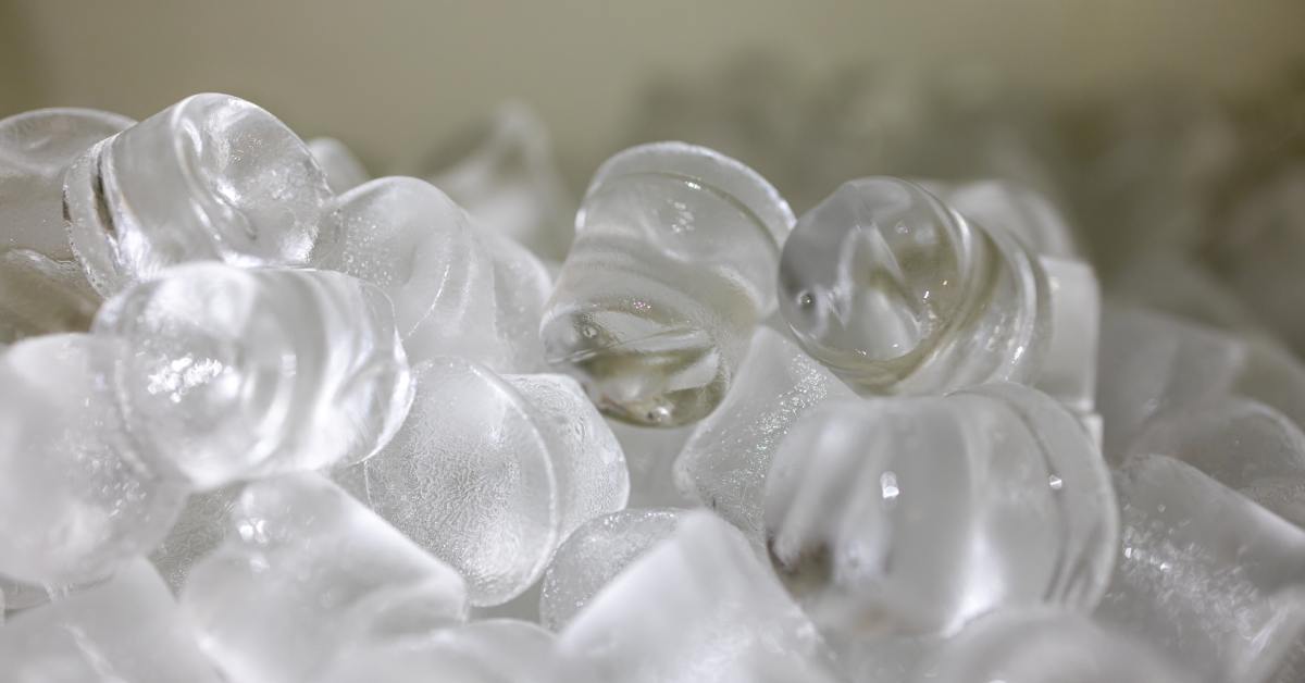 A close-up of clean food-grade ice pieces. The ice has a clear texture and a fresh frozen surface. fresh frozen surface.
