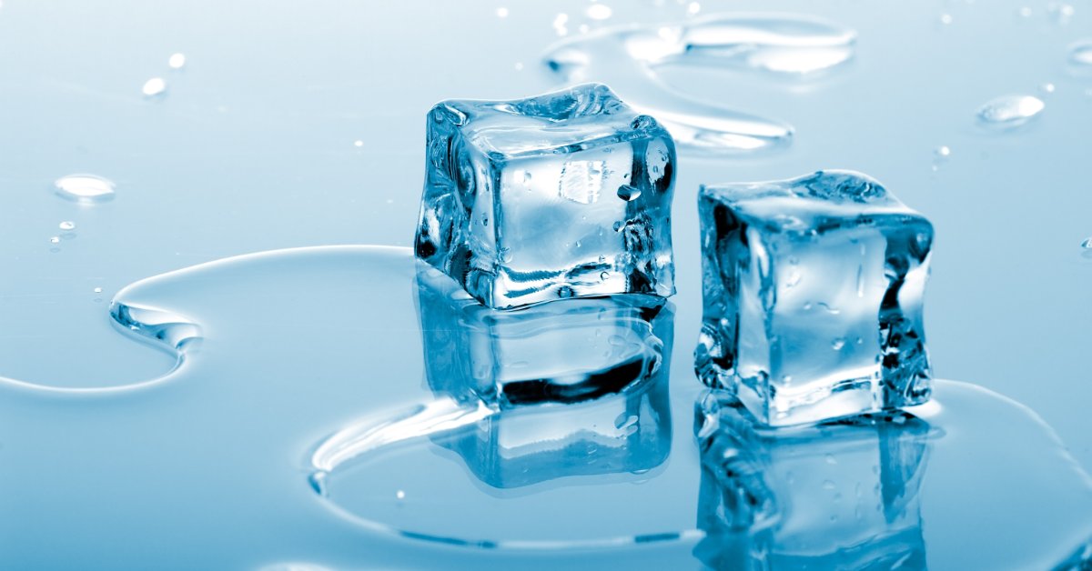 Two melting ice cubes sit in a shallow pool of water as smaller ice pieces blur across the cool blue background.